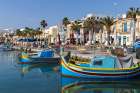 Malta, Marsaxlokk. Marsaxlokk harbor. Luzzijiet, colorful traditional Maltese fishing boats. Art Print